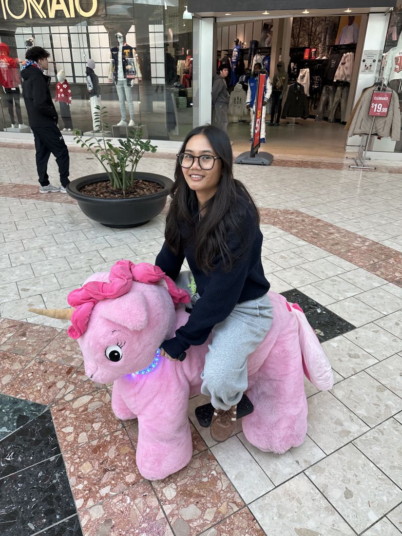Yas with a giant pink unicorn at a mall